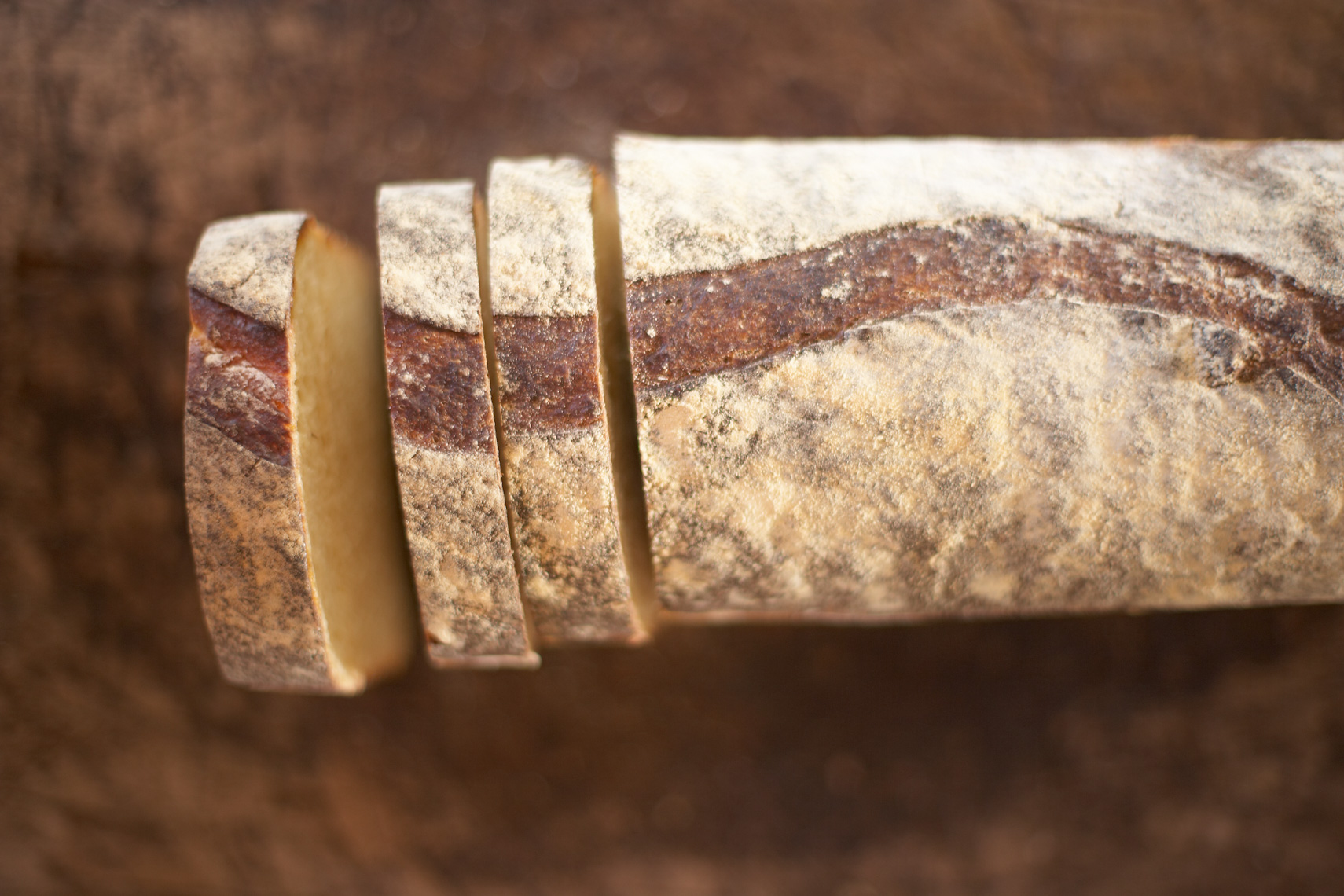 sliced homemade sourdough bread on woodboard San Francisco food photographer