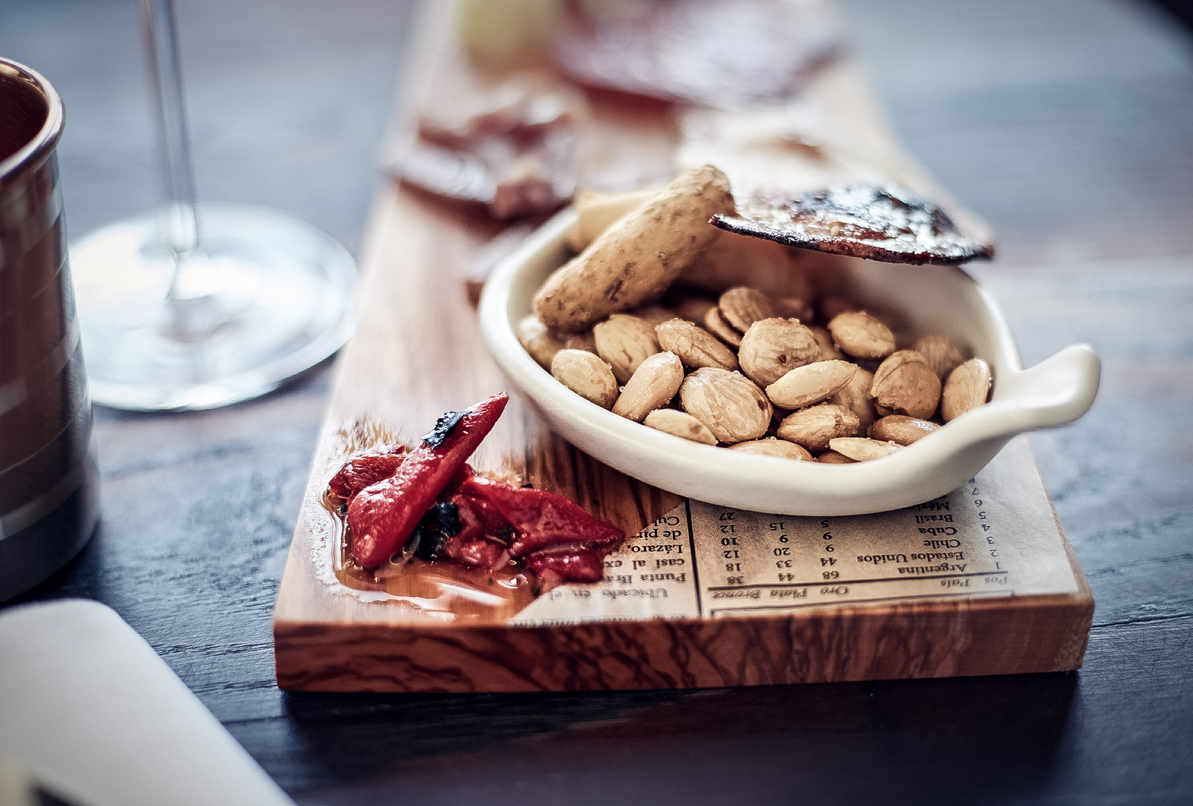 small white bowl with nuts on wooden surface with peppers San Francisco food photographer
