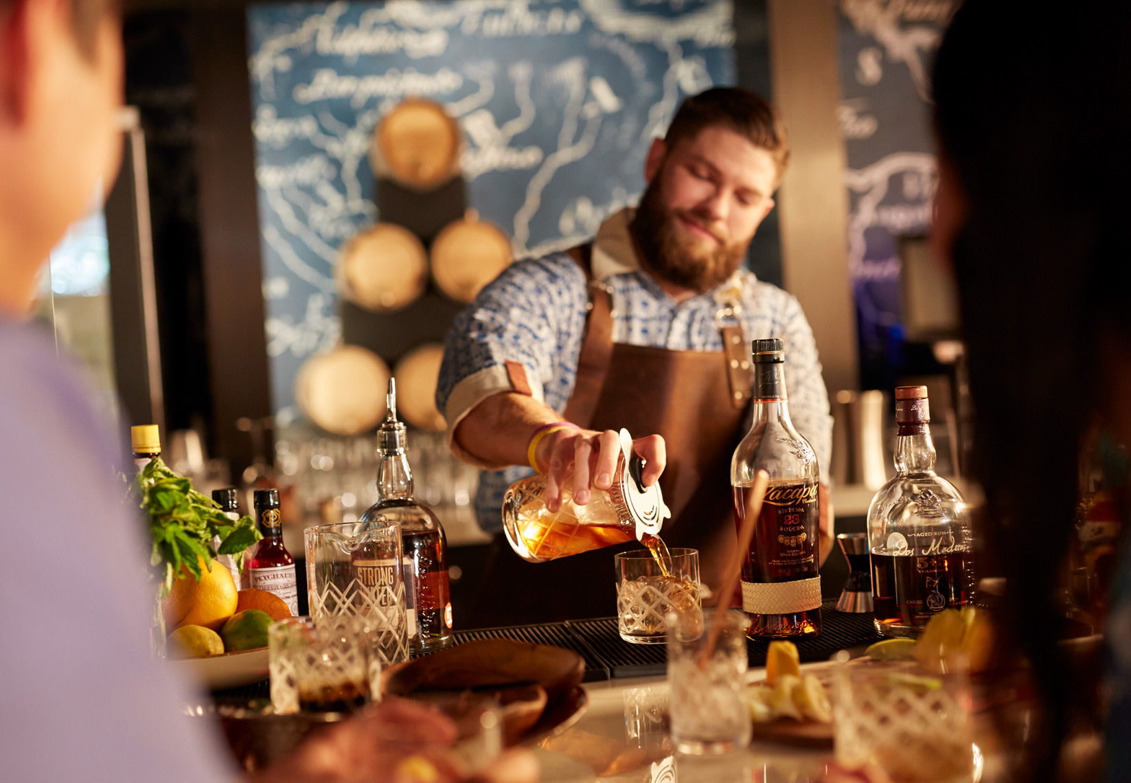 bartender pouring drink in jar into fresh glass in a bar San Francisco food photographer