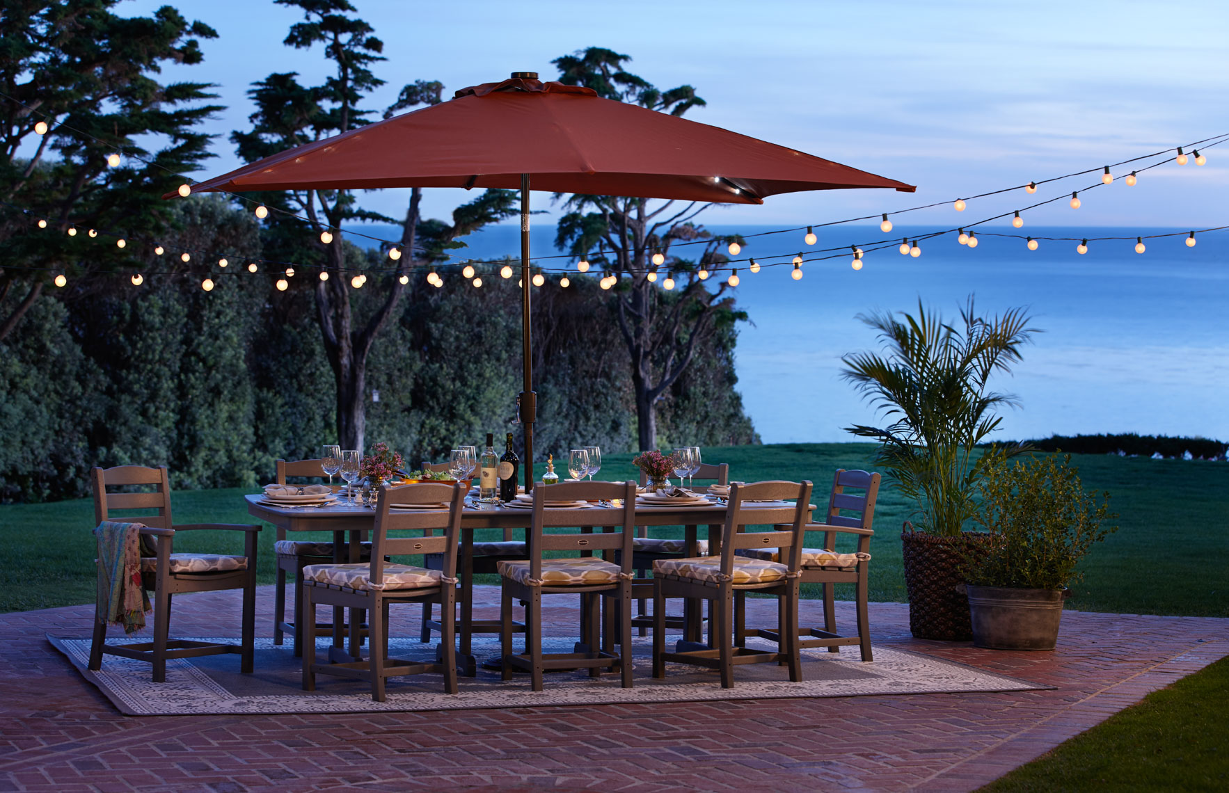 Wood Outdoor Furniture With Red Umbrella At Dusk On Patio By The Ocean San Francisco Lifestyle Photographer