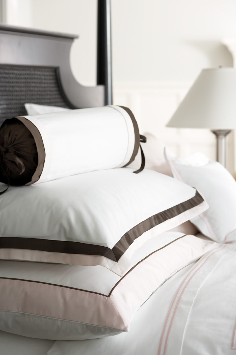 detail of white Italian bedding on bed with black headboard San Francisco product photographer