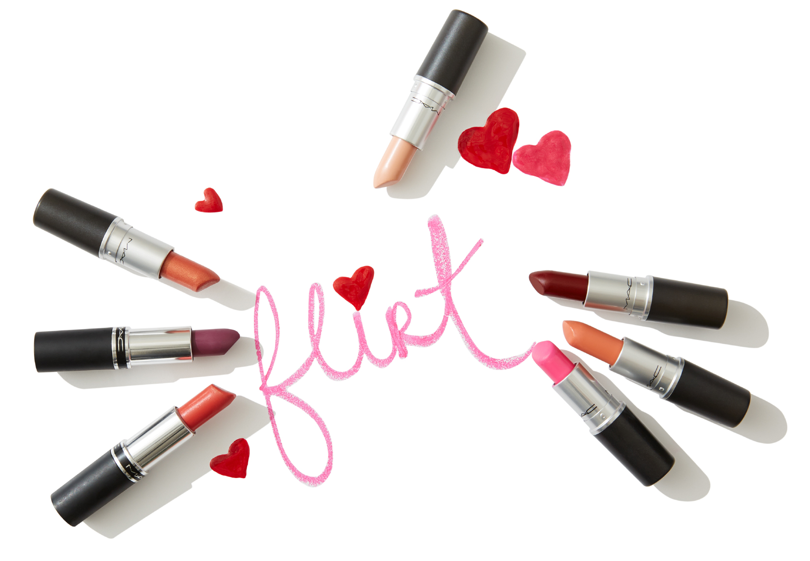 7 lipsticks surrounding the word flirt written in lipstick with hearts on white surface San Francisco product photographer