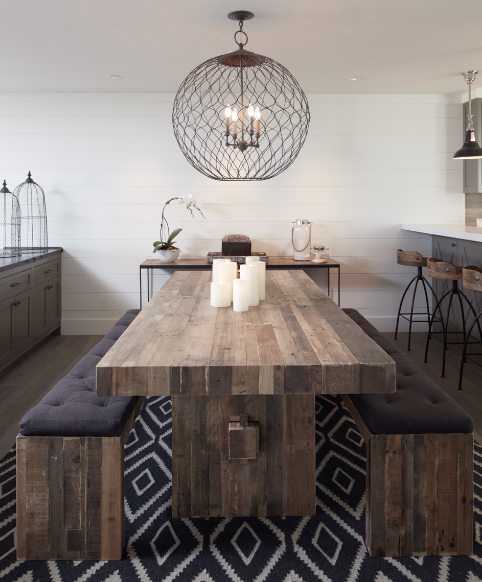 interior of wooden dining table with lit candles with benches and grey cushions San Francisco interior photographer